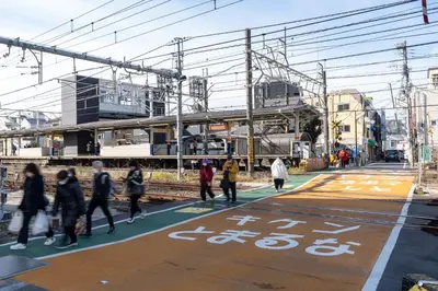 a group of people walking on a train platform at Gran Fusion\u6c60\u888b in Tokyo