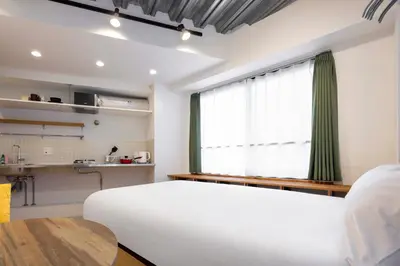 a bedroom with a white bed and a window at Gran Fusion\u6c60\u888b in Tokyo