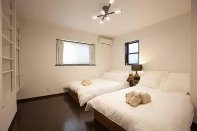 a bedroom with two beds and a window at ks\u897f\u65e9\u7a32\u7530 in Tokyo