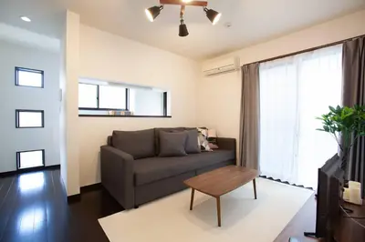 a living room with a couch and a table at ks\u897f\u65e9\u7a32\u7530 in Tokyo