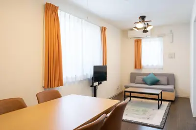 a living room with a table and a couch at Livecasa\u4e21\u56fd I in Tokyo