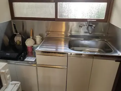 a kitchen with a sink and a microwave at Little Bird Takinogawa #1 in Tokyo