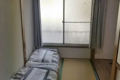 a room with a bed in front of a window at Little Bird Takinogawa #1 in Tokyo