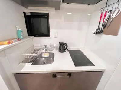 a small kitchen with a sink and a stove at FARE Akihabara - Stylish Spacious Studio 8min from Station 201 in Tokyo
