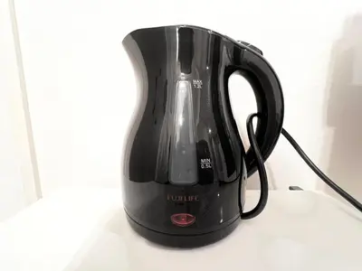 a black tea kettle sitting on top of a table at FARE Akihabara - Stylish Spacious Studio 8min from Station 201 in Tokyo