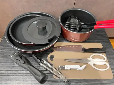 a table with a pan and a pot with utensils at FARE Akihabara - Stylish Spacious Studio 8min from Station 201 in Tokyo