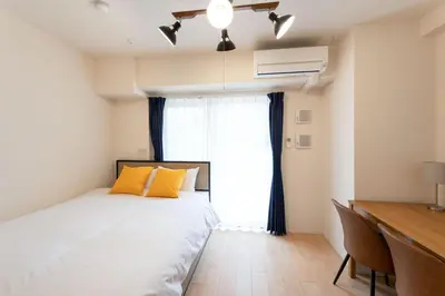 a bedroom with a bed and a desk and a window at KiSETSU\u795e\u697d\u5742 in Tokyo
