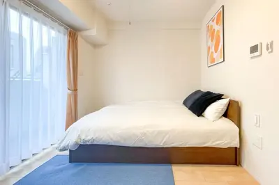 a bedroom with a bed with a large window at KiSETSU\u795e\u697d\u5742 in Tokyo