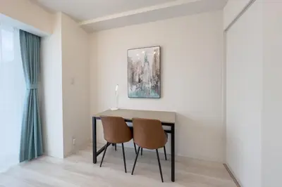a dining room table with two chairs and a painting at \u3055\u304f\u3089\u307f\u3061\u30c6\u30e9\u30b9 in Tokyo