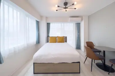 a bedroom with a bed and a table and chairs at \u3055\u304f\u3089\u307f\u3061\u30c6\u30e9\u30b9 in Tokyo