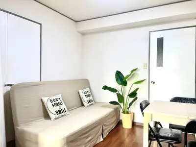 a living room with a couch and a table at Hotel KinRin in Tokyo