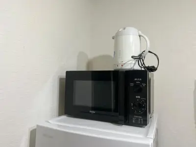 a microwave with a cup on top of it at Hotel KinRin in Tokyo