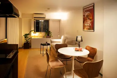 a living room with a white table and chairs at #9 3mins to station 1stop to Shinjuku Stylish apartment with plenty of sunlight in Tokyo