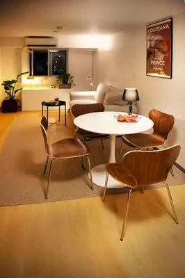 a living room with a table and chairs at #9 3mins to station 1stop to Shinjuku Stylish apartment with plenty of sunlight in Tokyo