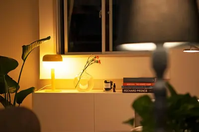 a table with a vase and a lamp on it at #9 3mins to station 1stop to Shinjuku Stylish apartment with plenty of sunlight in Tokyo
