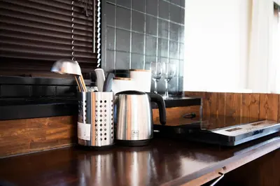 a counter top with two kettles on top of a kitchen counter at #9 3mins to station 1stop to Shinjuku Stylish apartment with plenty of sunlight in Tokyo