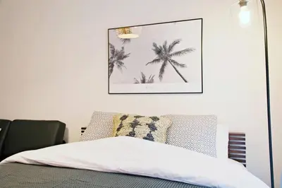 a bedroom with a bed with a picture on the wall at \u30bb\u30f3\u30c8\u30ec\u30a4 \u62bc\u4e0a\u30ce\u30fc\u30b9103 in Tokyo