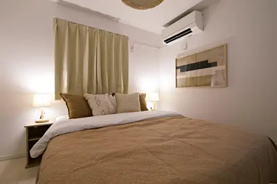 a bedroom with a large bed and a window at \u897f\u5de3\u9d28HOUSE in Tokyo