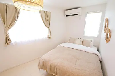 a white bedroom with a bed and a window at \u897f\u5de3\u9d28HOUSE in Tokyo