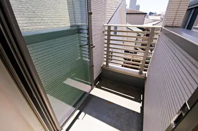 a balcony with a glass door on a building at \u897f\u5de3\u9d28HOUSE in Tokyo