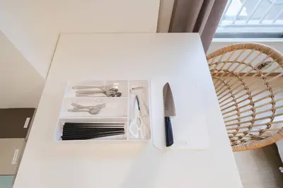 a white table with utensils on top of it at Takadanobaba Address102 in Tokyo