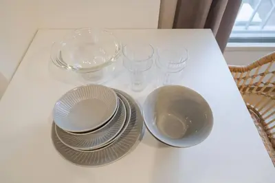 a white table with plates and glasses on it at Takadanobaba Address102 in Tokyo