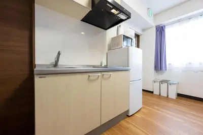 a kitchen with a sink and a refrigerator at \u4eca\u548cHotel in Tokyo