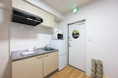 a kitchen with a sink and a refrigerator at \u4eca\u548cHotel in Tokyo