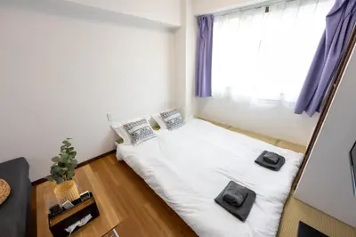 a small bedroom with a bed and a window at \u4eca\u548cHotel in Tokyo
