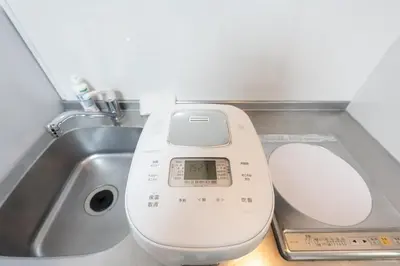 a scale sitting next to a sink next to a toilet at \u4eca\u548cHotel in Tokyo