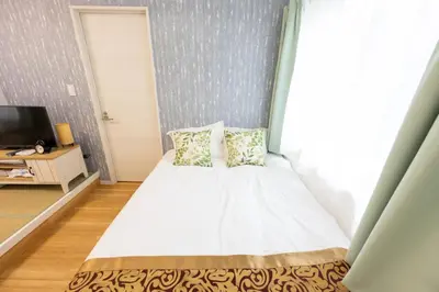 a small bedroom with a bed and a window at \u4eca\u548cHotel in Tokyo