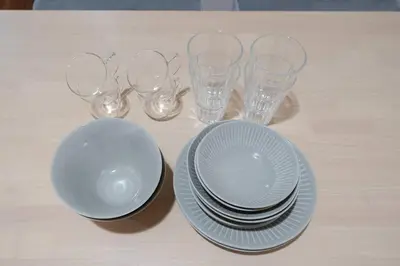 a table with plates and glasses on a table at Shibuya E Address 303 in Tokyo