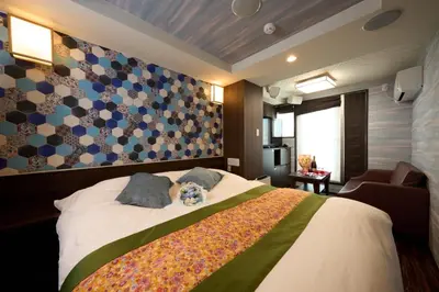 a bedroom with a large bed and a couch at Hotel Opera in Tokyo