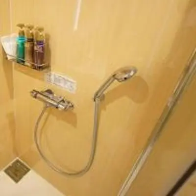 a shower with a hose in a bathroom at Hotel Opera in Tokyo