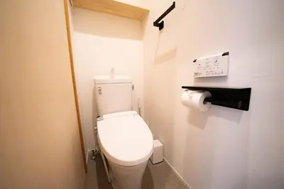a bathroom with a white toilet and a roll of toilet paper at SHITAMACHI PLACE TOKYO in Tokyo