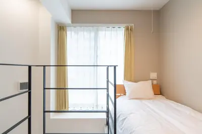 a bedroom with a bed and a window at The Sanctus \u6075\u6bd4\u5bff in Tokyo