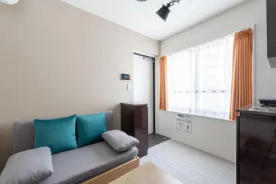 a living room with a couch and a window at The Sanctus \u6075\u6bd4\u5bff in Tokyo