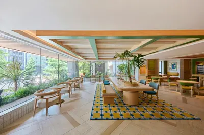 a lobby with tables and chairs and windows at The Royal Park Hotel Ginza 6-Chome in Tokyo