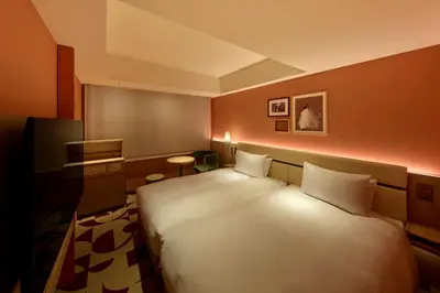 a bedroom with a large white bed in a room at The Royal Park Hotel Ginza 6-Chome in Tokyo