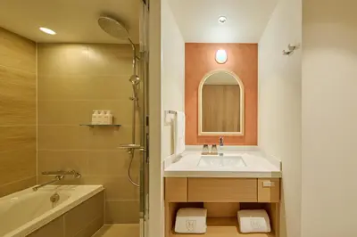 a bathroom with a sink and a shower and a tub at The Royal Park Hotel Ginza 6-Chome in Tokyo