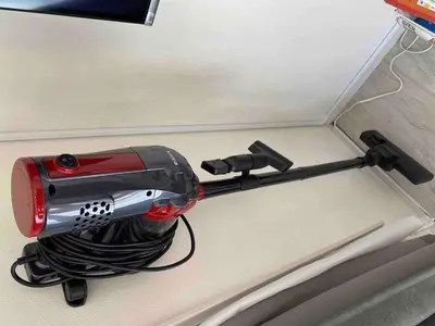 a red and black corded hair dryer hanging from a wall at \uff28\uff2f\uff34\uff25\uff2c\u3000\uff25\uff2c\u30009 in Tokyo