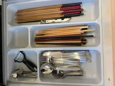 a plastic container filled with utensils and wooden chopsticks at \uff28\uff2f\uff34\uff25\uff2c\u3000\uff25\uff2c\u30009 in Tokyo