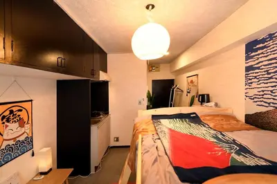 a bedroom with a bed in a room with a kitchen at \u65b0\u5bbfJAPANNING\u30cf\u30a6\u30b9 in Tokyo
