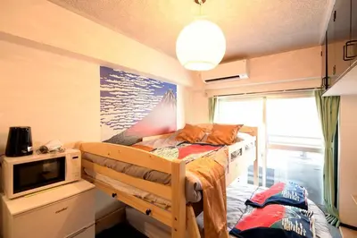 a bedroom with a bunk bed and a microwave at \u65b0\u5bbfJAPANNING\u30cf\u30a6\u30b9 in Tokyo