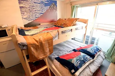 a bedroom with two bunk beds and a microwave at \u65b0\u5bbfJAPANNING\u30cf\u30a6\u30b9 in Tokyo