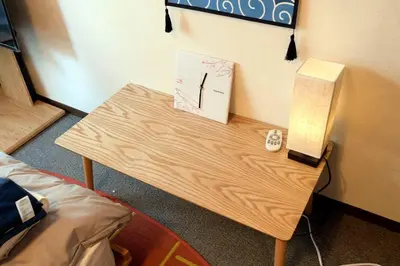 a wooden table with a lamp and a phone on it at \u65b0\u5bbfJAPANNING\u30cf\u30a6\u30b9 in Tokyo