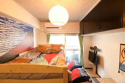 a bedroom with a bed and a tv in it at \u65b0\u5bbfJAPANNING\u30cf\u30a6\u30b9 in Tokyo