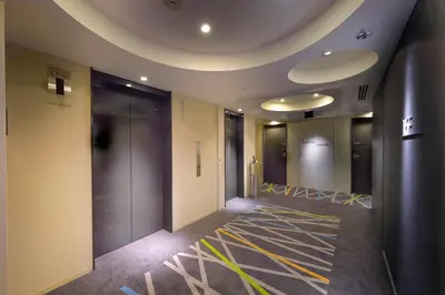 a hallway of an office building with a painting on the floor at Sotetsu Fresa Inn Shimbashi-Karasumoriguchi in Tokyo