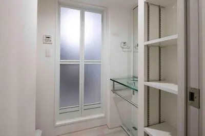 a glass door in a room with a window at KiSETSU\u65e9\u7a32\u7530II in Tokyo