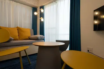 a living room with a couch and a table at Kisa in Tokyo